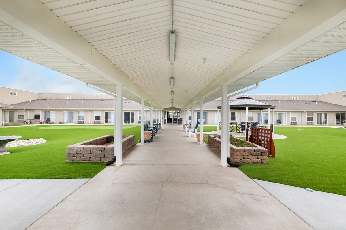 A covered walkway running through BelVilla’s landscaped courtyard.